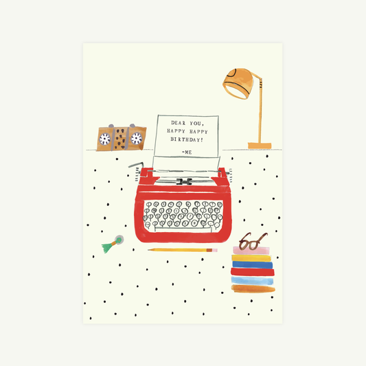 Illustration of a red typewriter with stationery items on a polka dot background