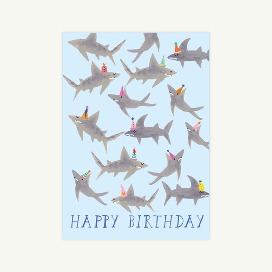 Birthday card with shark illustrations and 'Happy Birthday' text on a light blue background