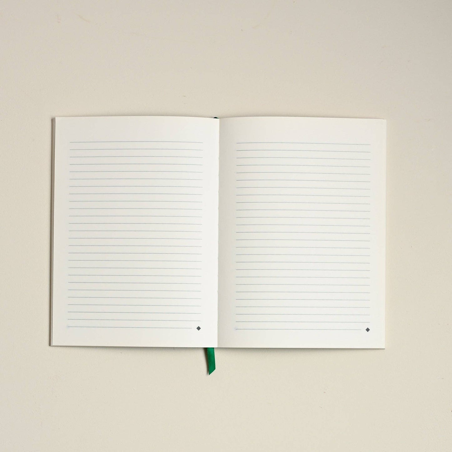 Open notebook with lined pages on a beige background