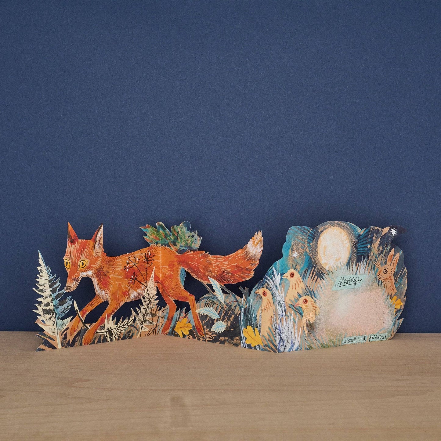 Decorative wall art with a fox and nature elements on a blue background