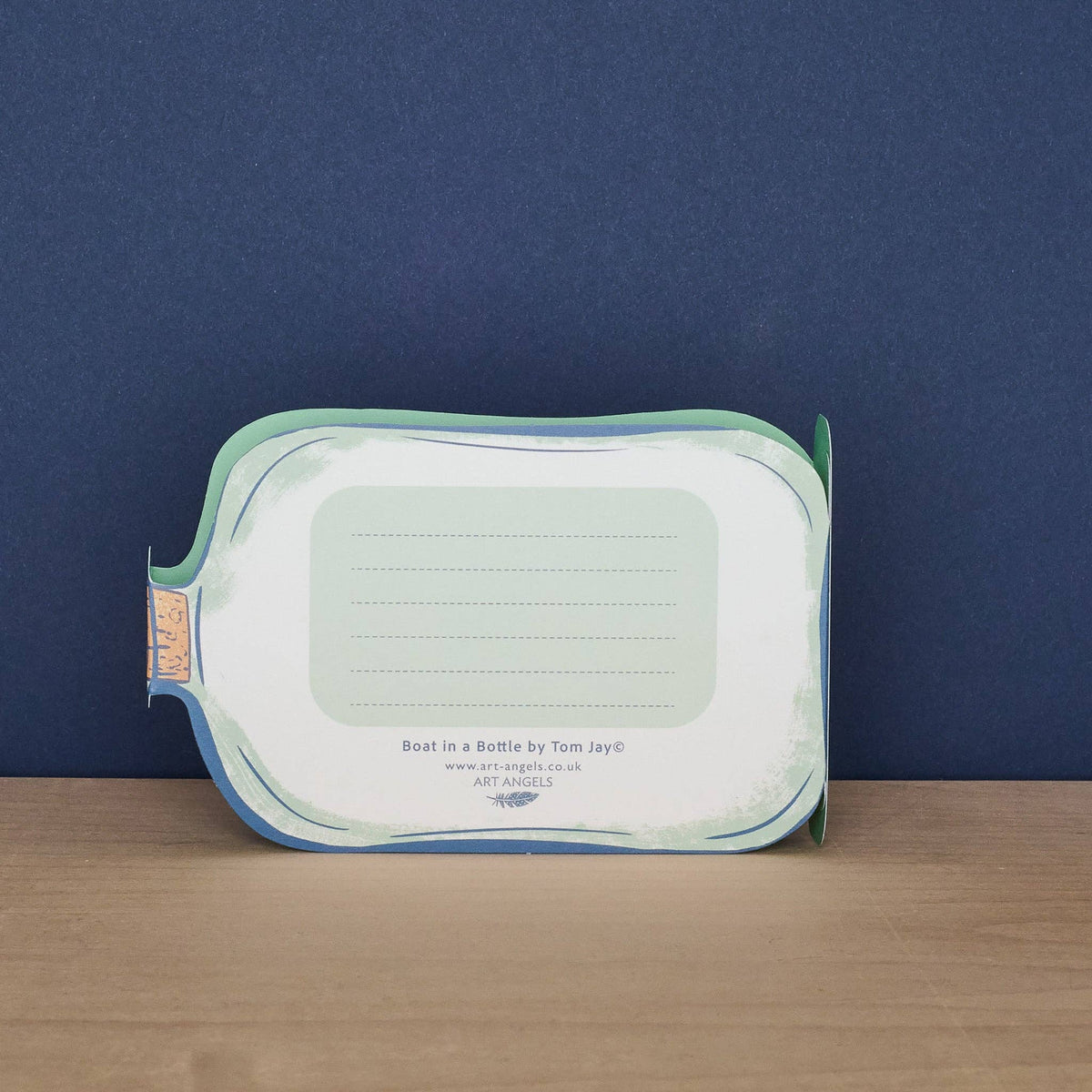 Rectangular ceramic tray with a blue rim on a wooden surface against a dark blue background