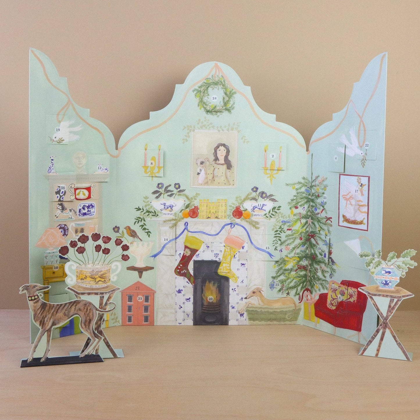 Decorative paper scene with various elements on a wooden surface and beige background