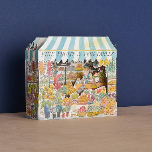 Decorative box with a market scene design on a blue background
