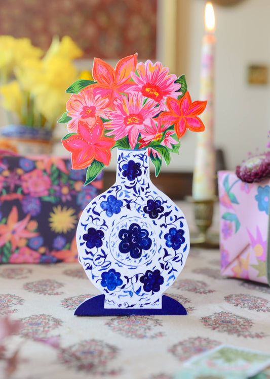 Decorative vase with floral design on a table with colorful background
