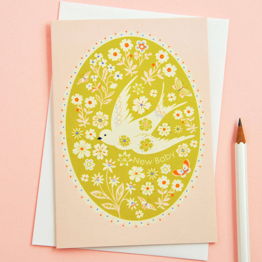 Greeting card with floral design and bird illustration on a pink background