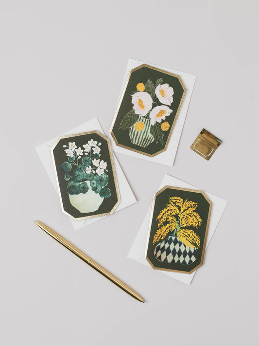 Three floral cards with green borders on a light gray background