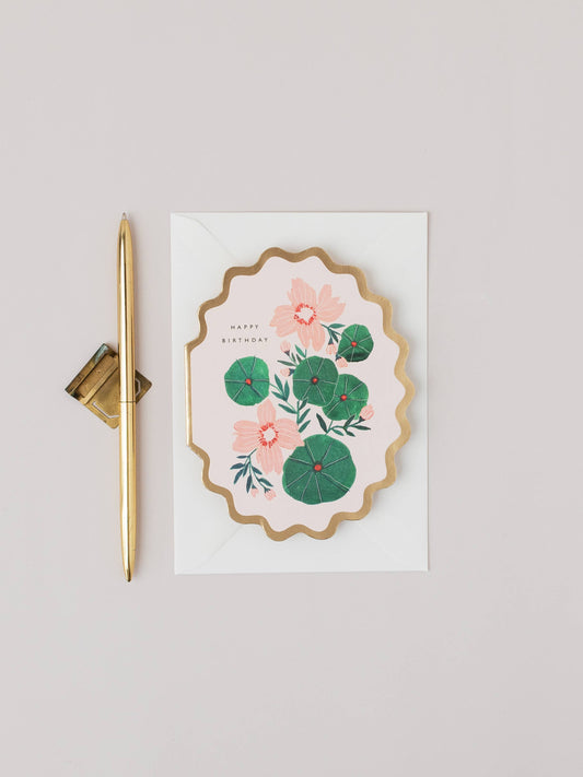Floral card with gold pen on a light gray background