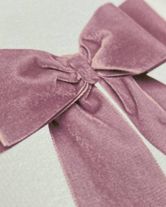 Close-up of a mauve velvet bow on a light background