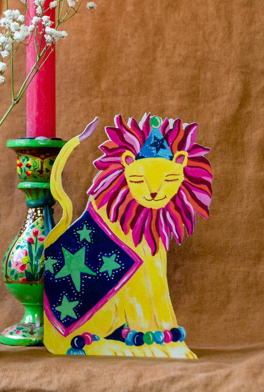 Colorful lion figurine with a starry design on a brown background