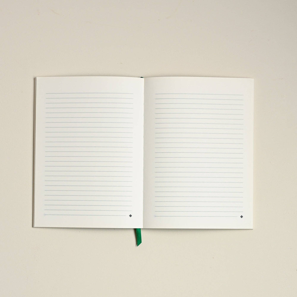 Open notebook with lined pages on a beige background