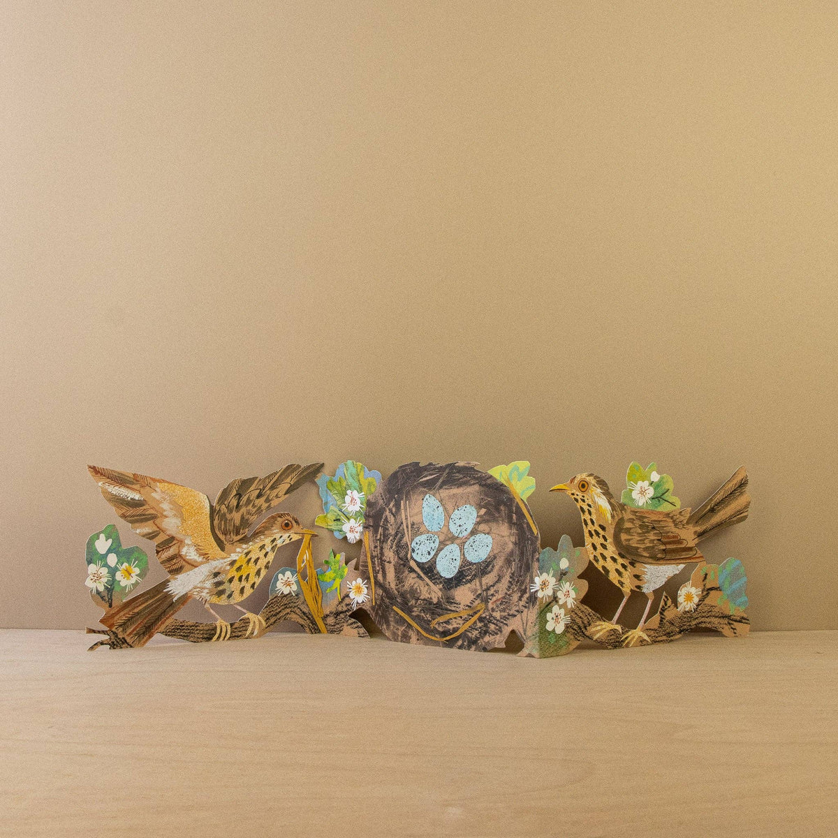 Decorative wall art with birds and flowers on a beige background