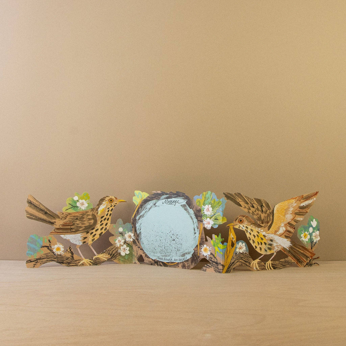 Decorative wall art with birds and flowers on a beige background