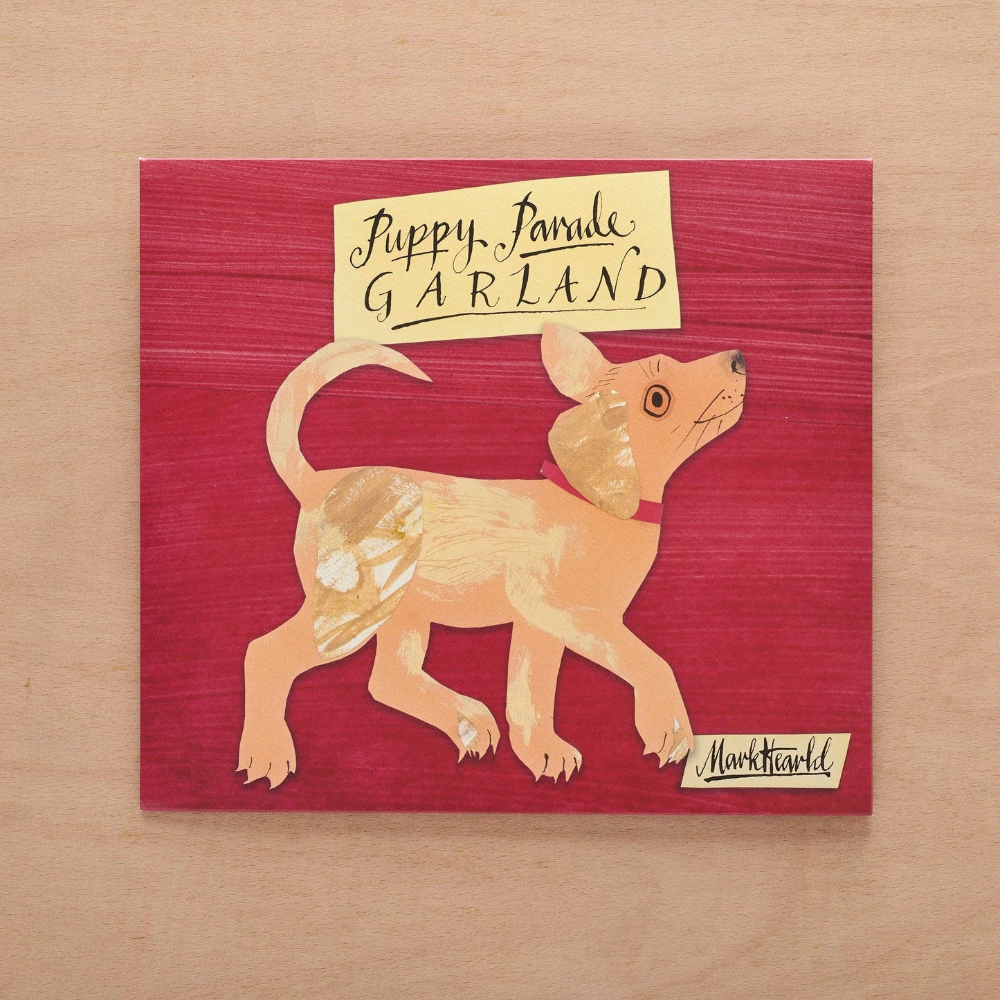 Illustration of a dog with a sign on a red background, signed by Mark Hearld.