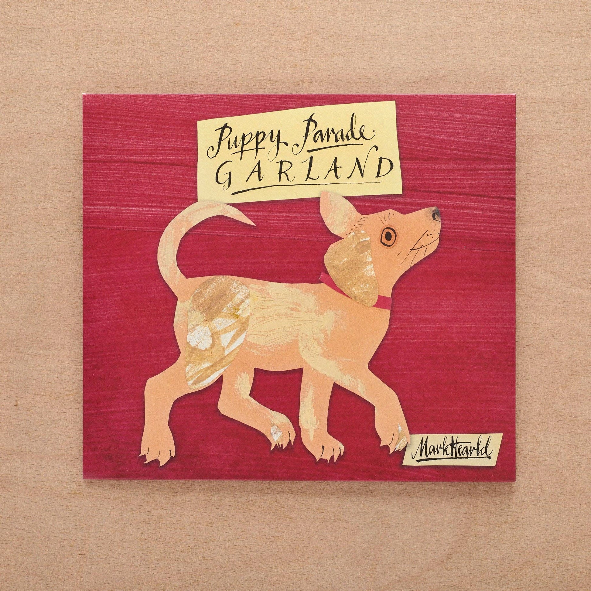 Illustration of a dog with a sign on a red background, signed by Mark Hearld.