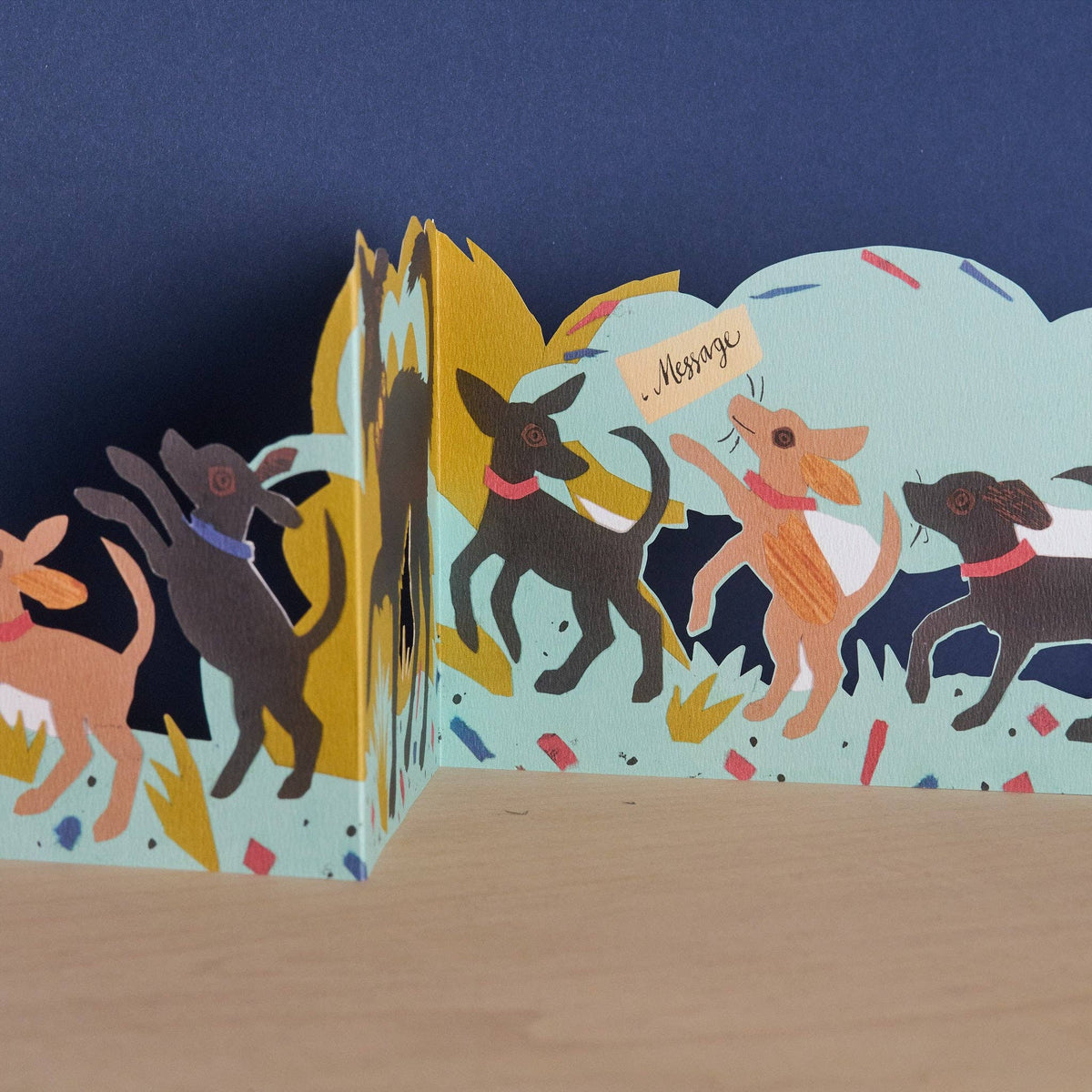 Pop-up card with dog illustrations on a blue background