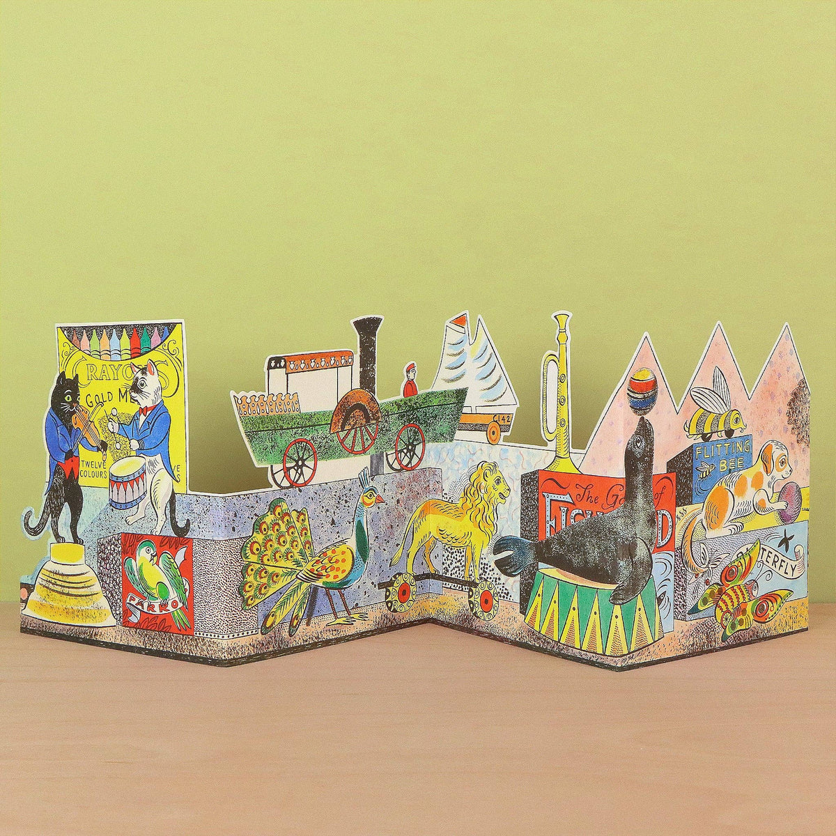 A colorful 3D pop-up cardboard book about The Great Train Robbery, displayed on a wooden surface against a light green background.