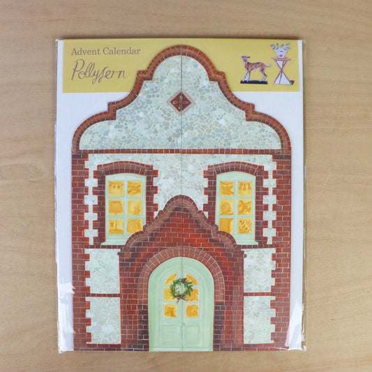 Advent calendar with a decorative house design on a wooden surface