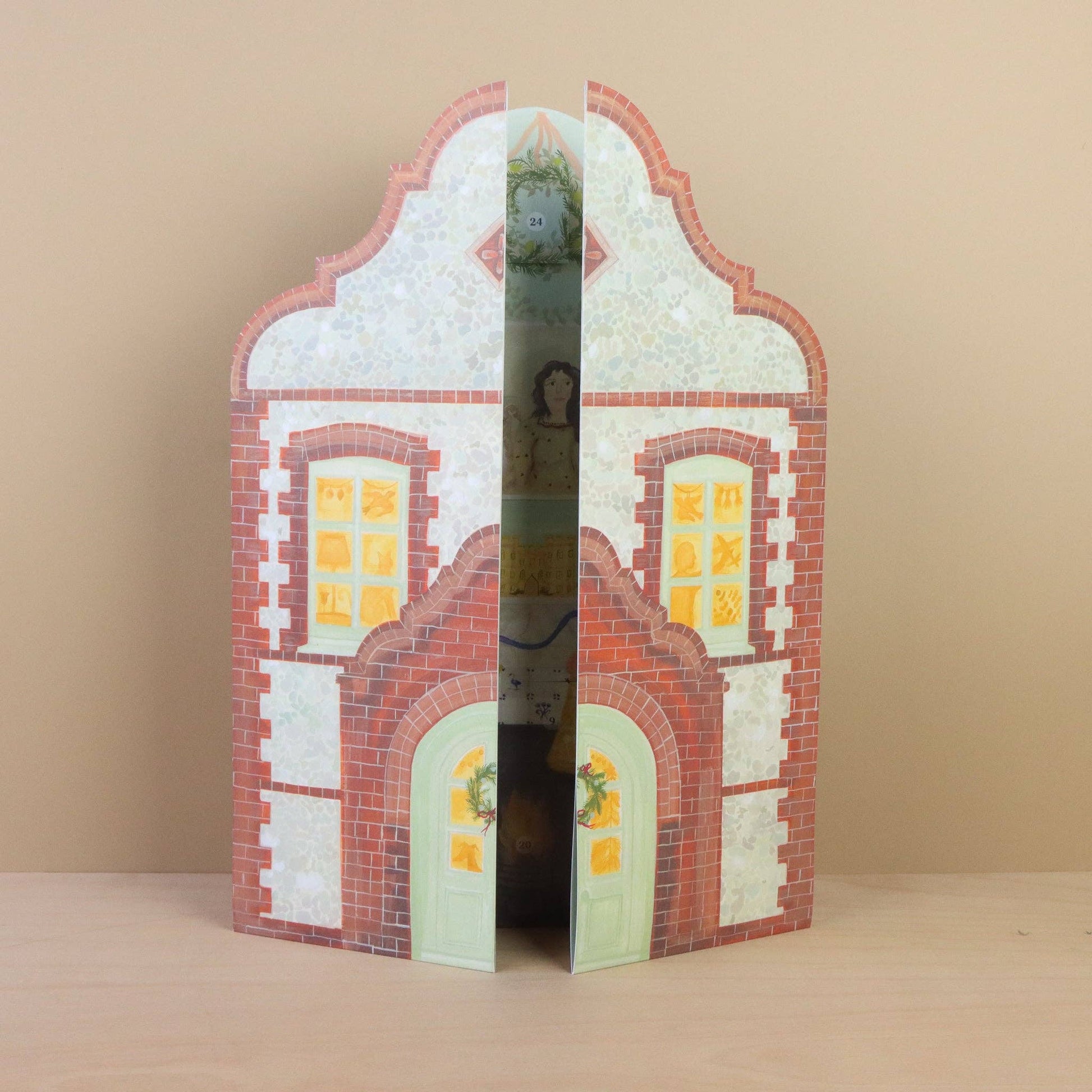 Decorative paper house with architectural details on a beige background