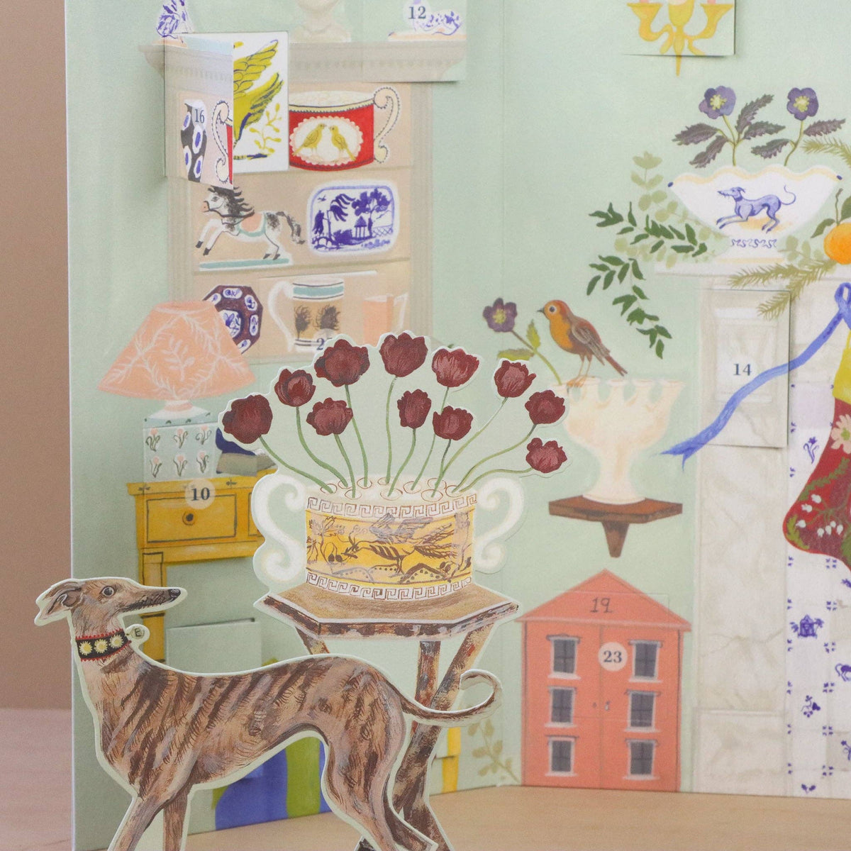 Decorative paper with various illustrations including a dog, flowers, and buildings on a light green background.