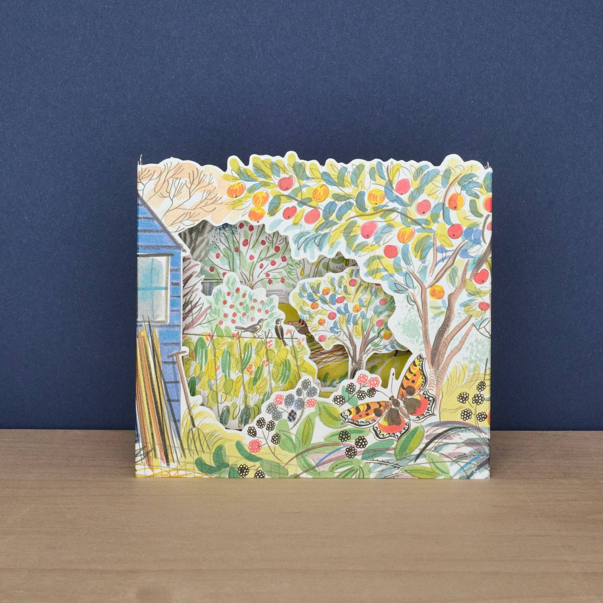 Colorful children's book with a garden illustration on a wooden surface and blue background