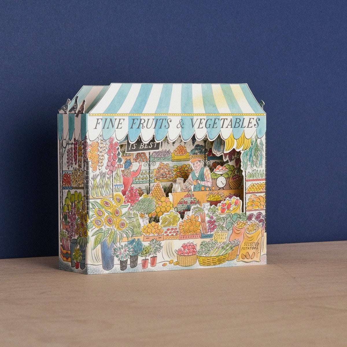 Decorative box with a market scene design on a blue background