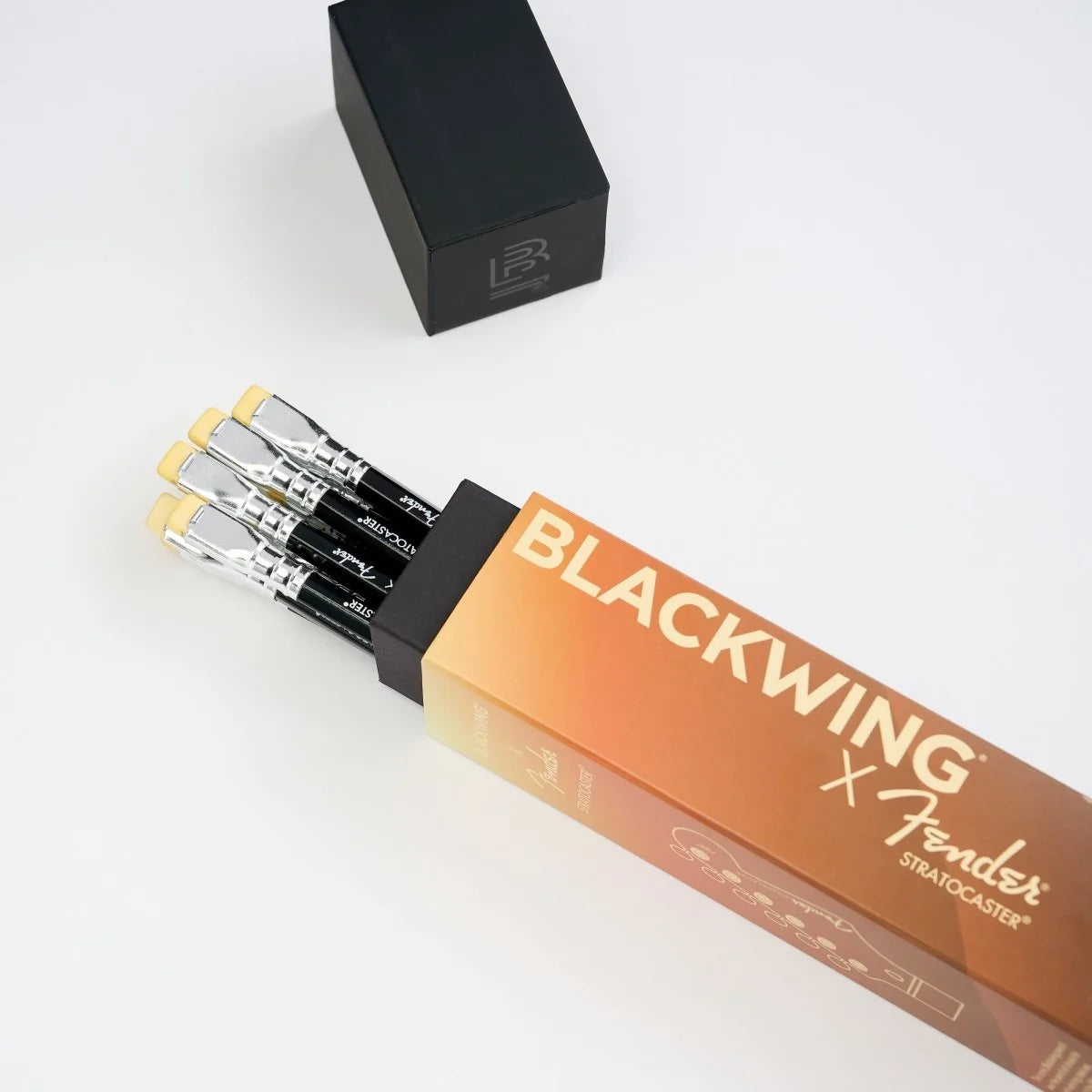 Pack of Blackwing pencils with a gradient packaging design, featuring the Fender Stratocaster logo.