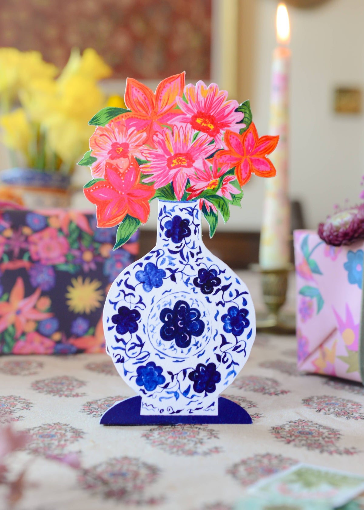 Decorative vase with floral design on a table with colorful background