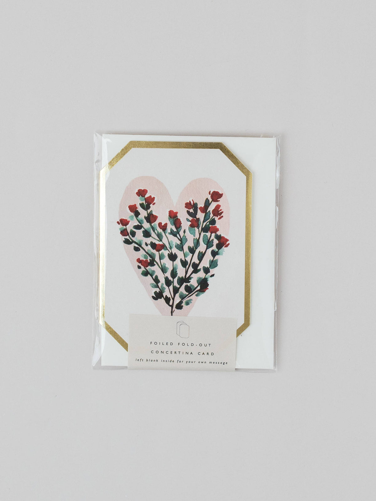 Card with floral heart design on a gray background