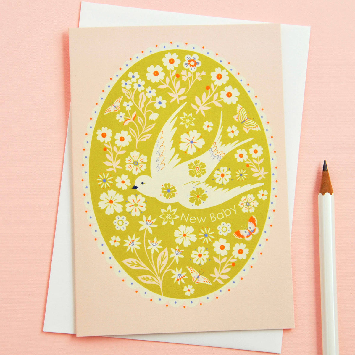 Greeting card with floral design and bird illustration on a pink background