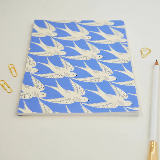 Notebook with bird pattern on a light gray background