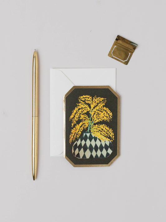 Decorative card with yellow floral design on a gray background