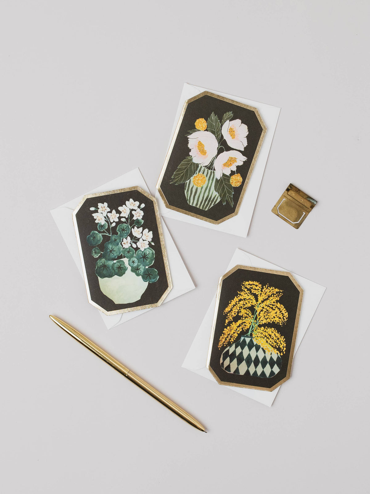 Three floral cards with green borders on a light gray background