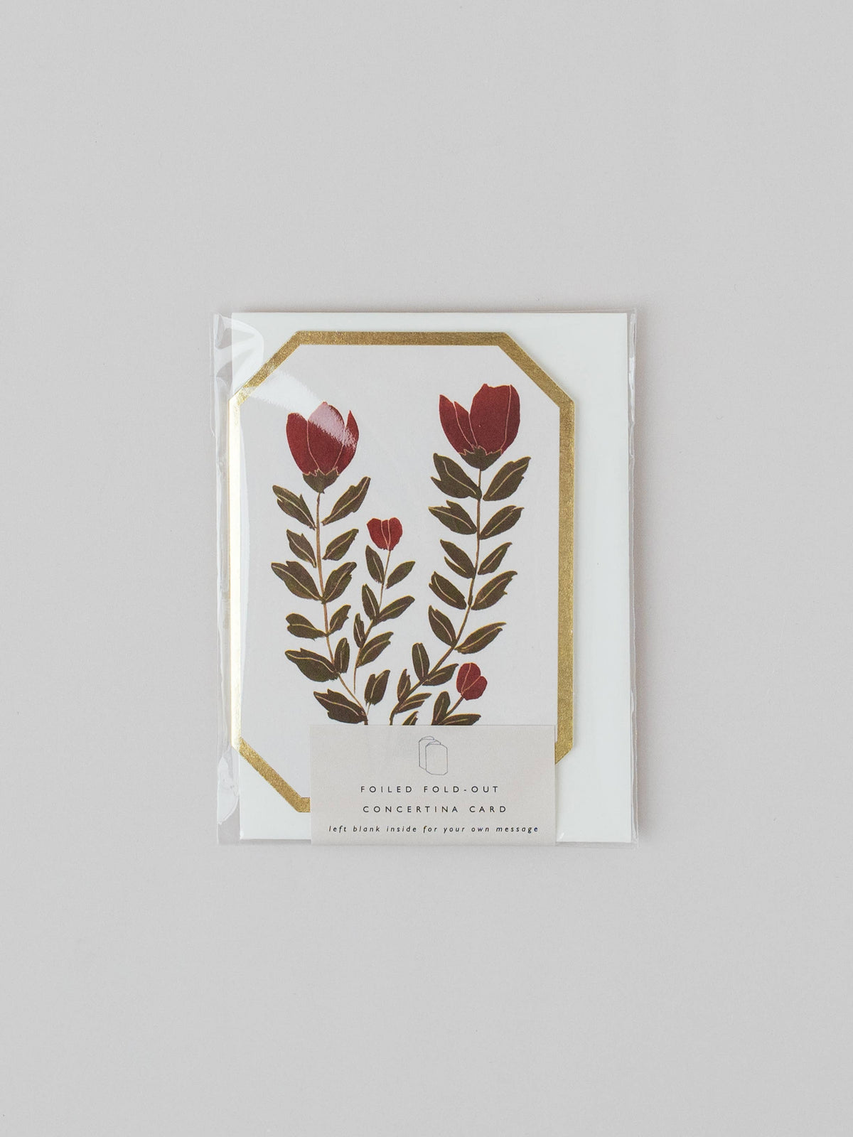 Floral design card with red flowers and green leaves on a white background