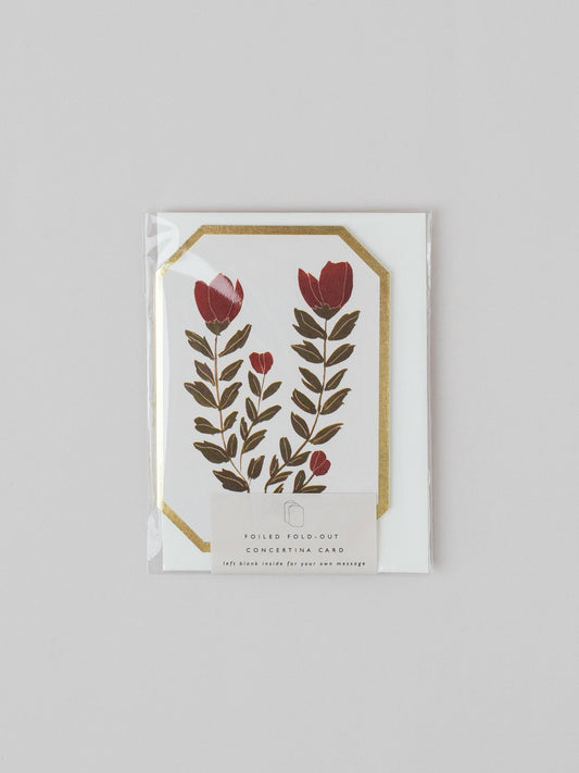 Floral design card with red flowers and green leaves on a white background