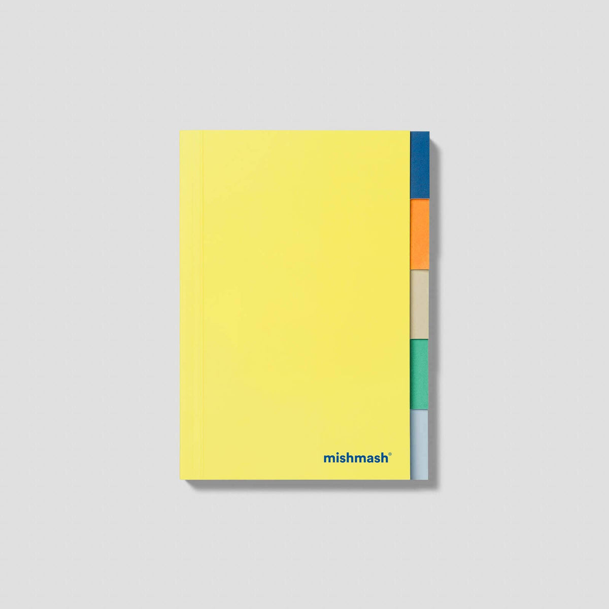 A yellow notebook with colorful page dividers in blue, orange, beige, green, and gray, displayed on a light gray background. The brand name 'mishmash' is printed in blue at the bottom of the notebook.