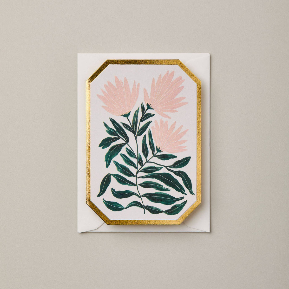 Decorative card with pink flowers and green leaves on a beige background