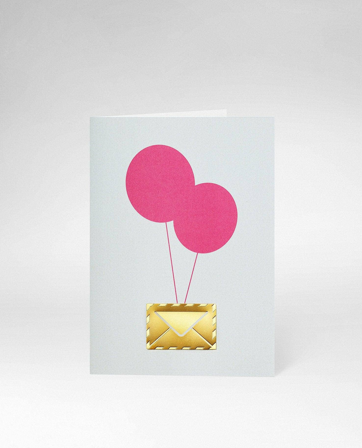 A minimalist greeting card featuring two pink paper balloons attached to a gold envelope illustration, set against a clean light gray background.