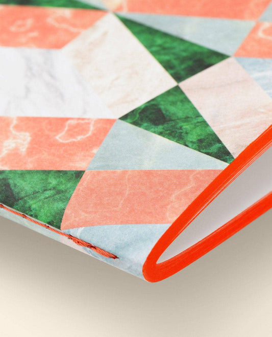 Colorful quilt with geometric pattern on a neutral background