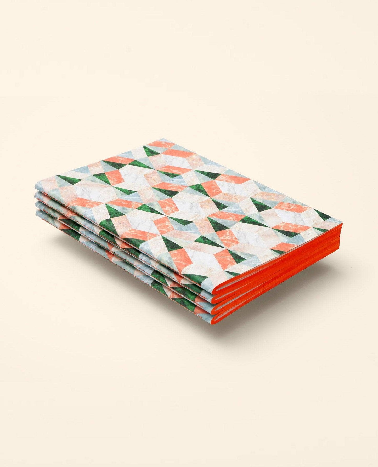 Stack of notebooks with geometric pattern on a beige background