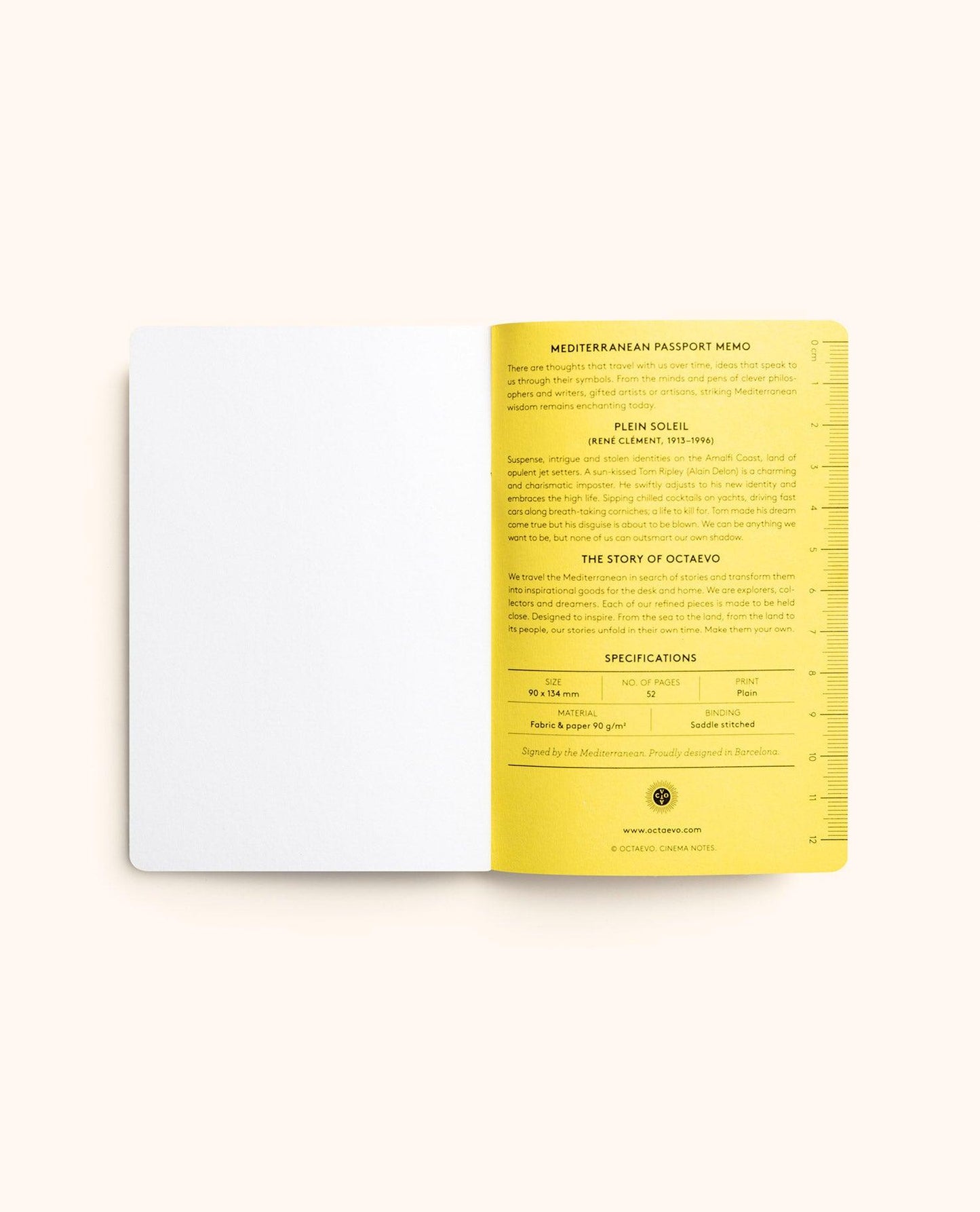 An open book or booklet on a light beige background, showing a blank white left page and a yellow right page with printed text and a small circular logo near the bottom.