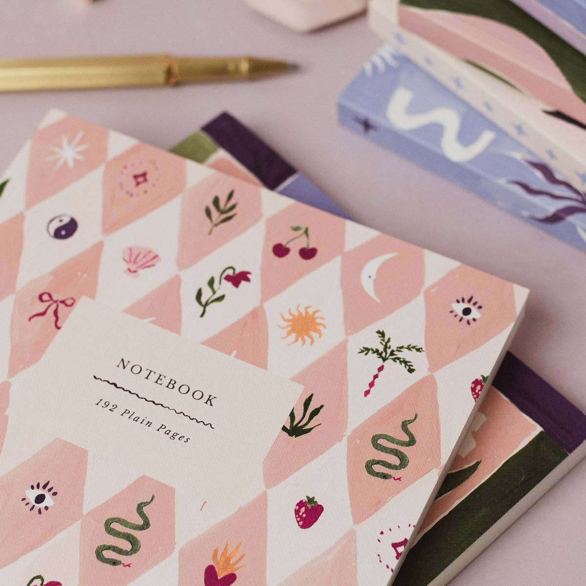 Notebook with geometric pattern and illustrations on a light surface
