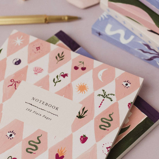 Notebook with geometric pattern and illustrations on a light surface