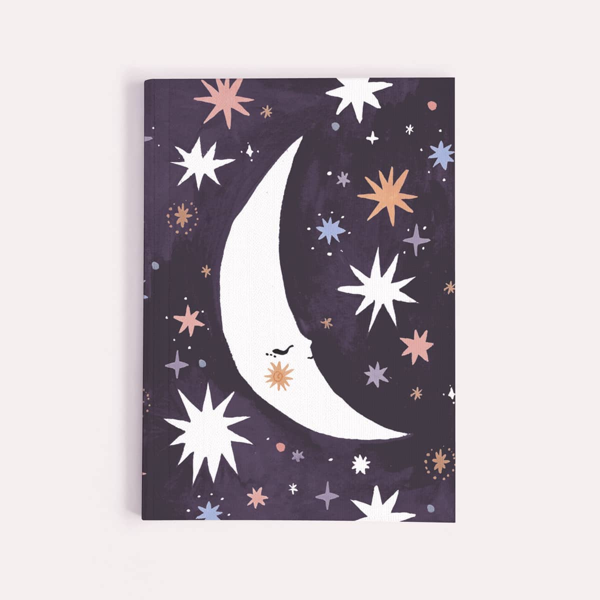 Notebook with a moon and star design on a purple background
