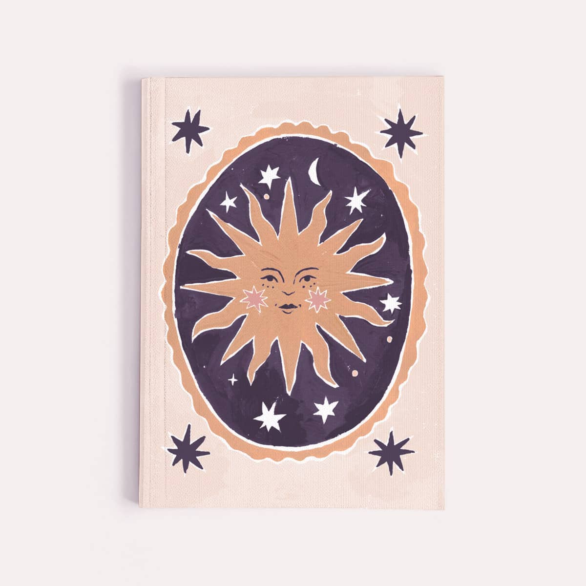 Notebook with sun and star design on a beige background