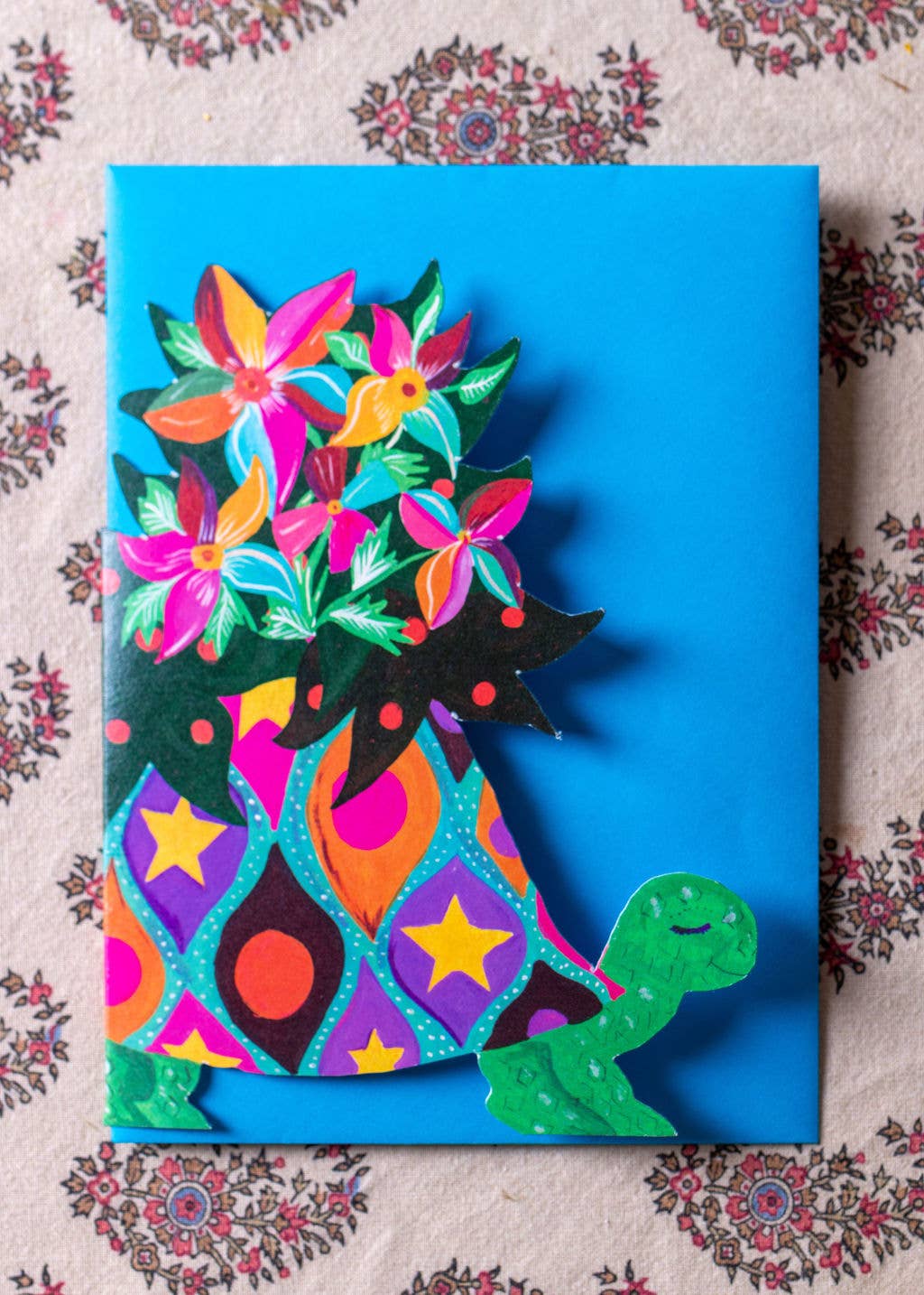 Colorful greeting card with a patterned design on a floral background