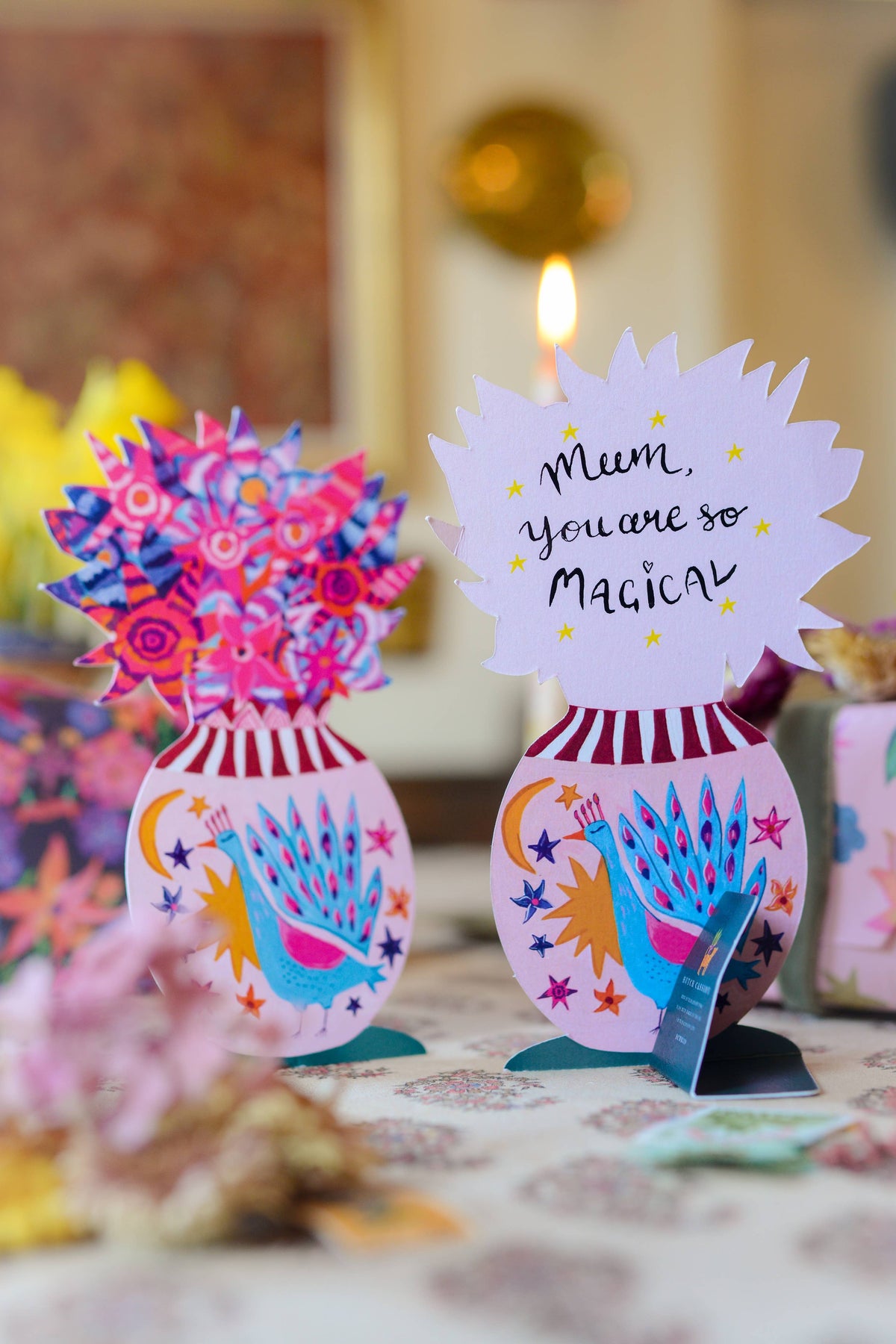 Decorative card with colorful vase and flowers on a table