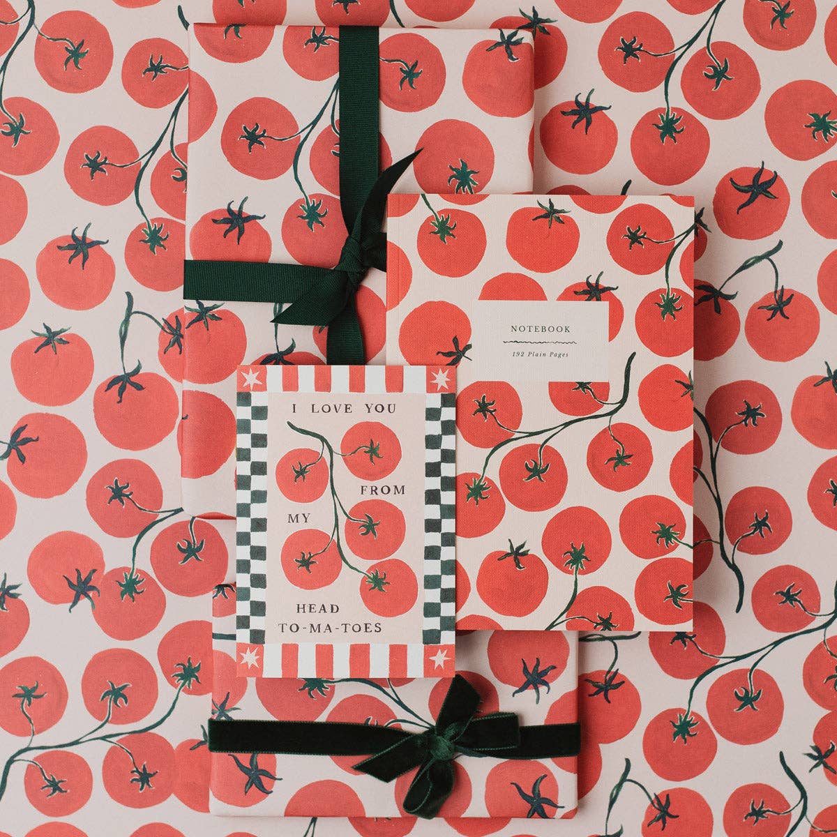 Gift set with tomato pattern on wrapping paper, card, and notebook.