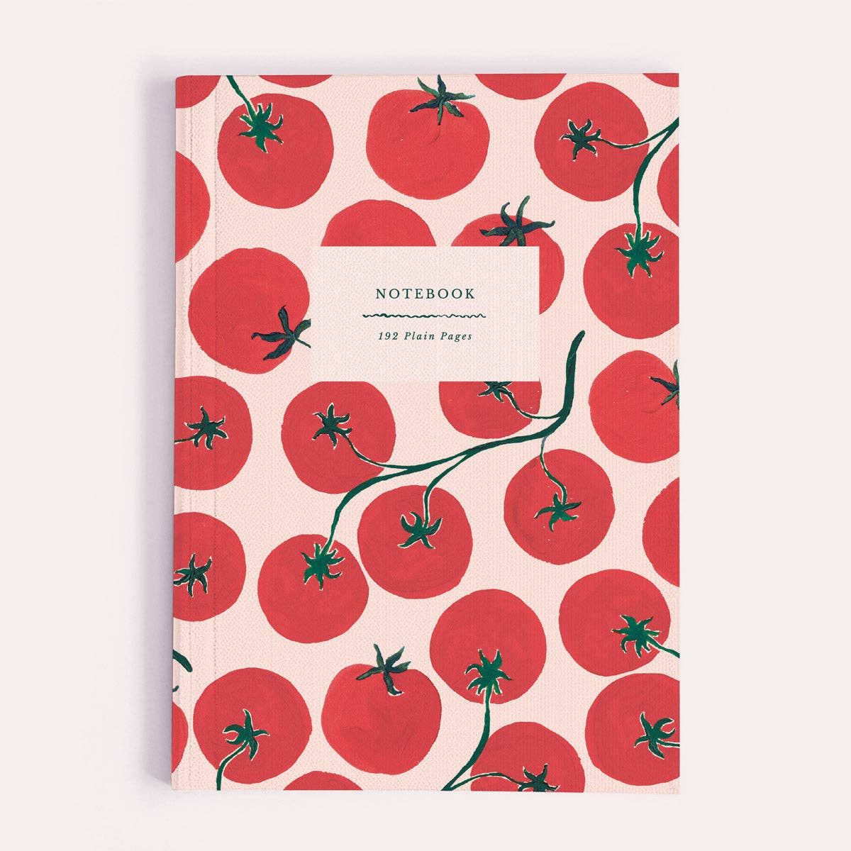 Notebook with red tomato pattern on a beige background