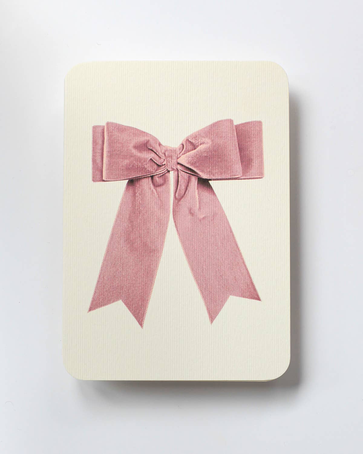 Beige card with a pink bow on a white background